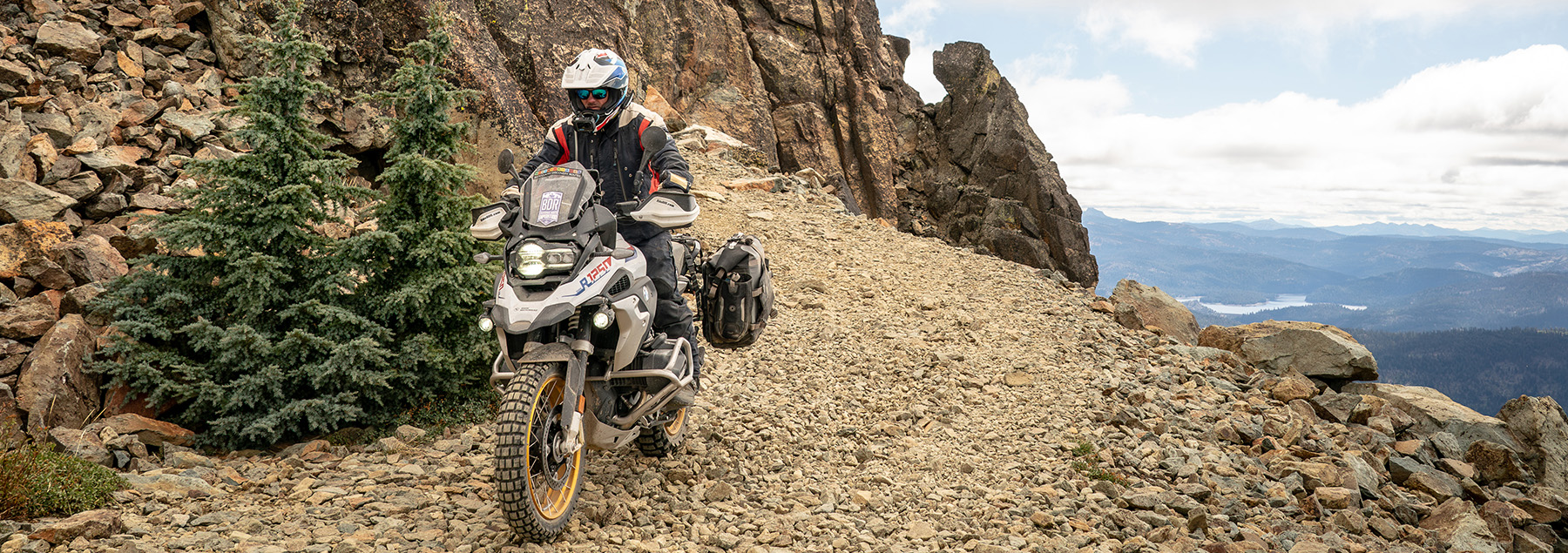 A BMW Motorcycle riding on a mountain.
