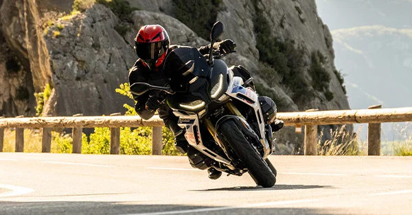 BMW R 1300 RS sport-touring bike leaned into a canyon road corner at speed