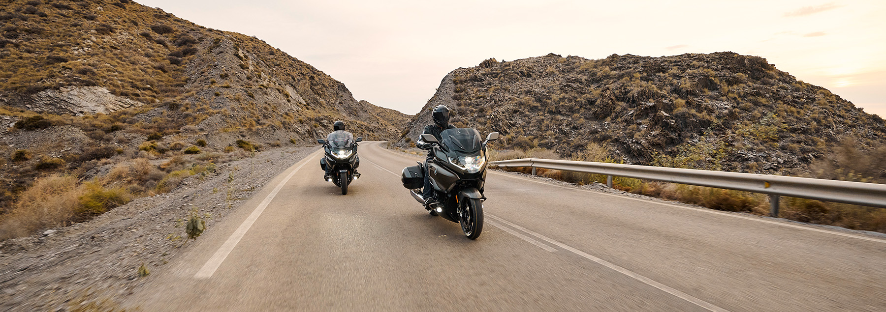 Two BMW Motorcycles riding on a bridge in Northern California.